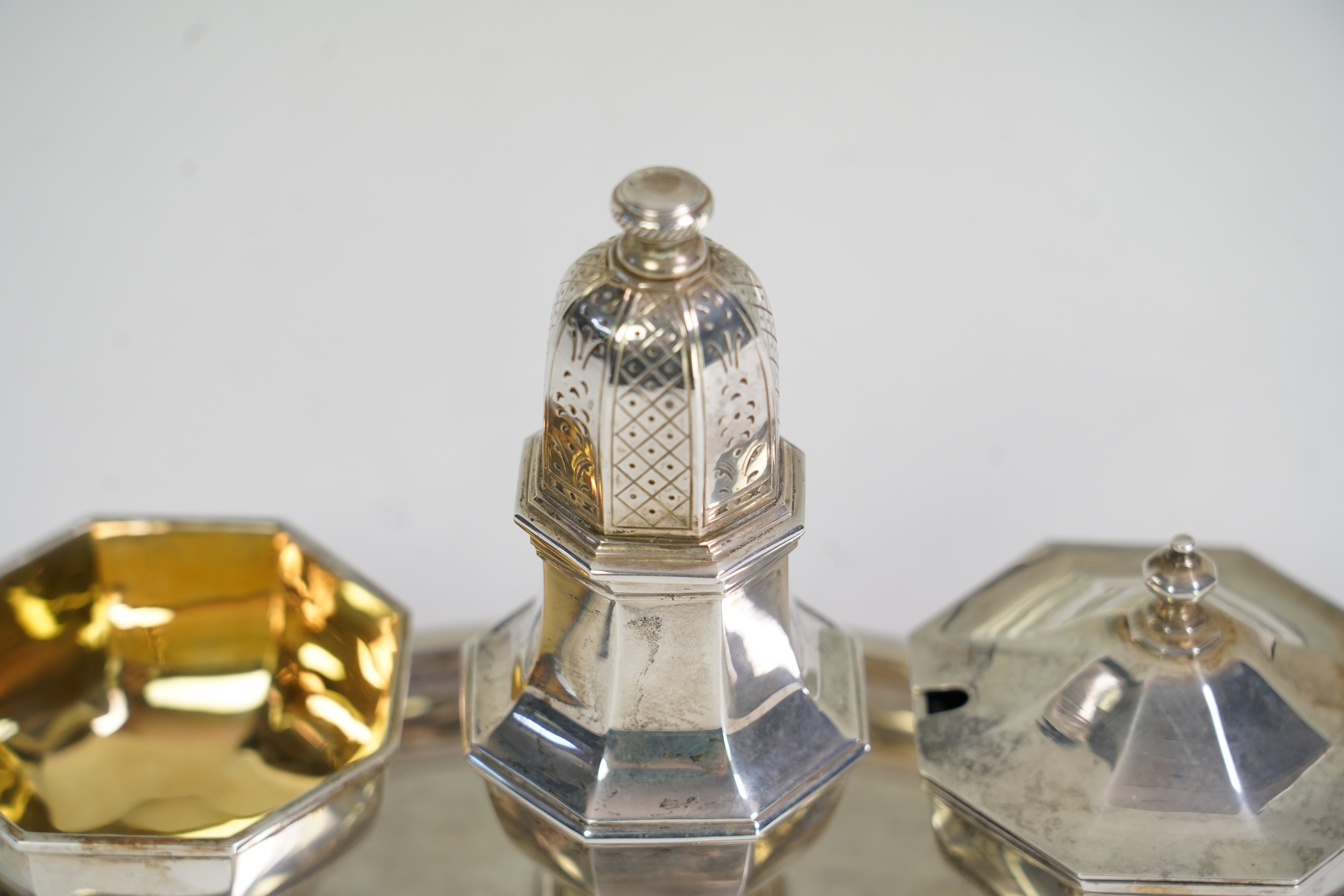 An Elizabeth II Asprey & Co silver three piece condiment set on stand